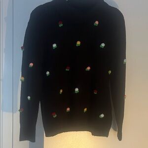 Chic Black Sweater with Vibrant Pom Poms